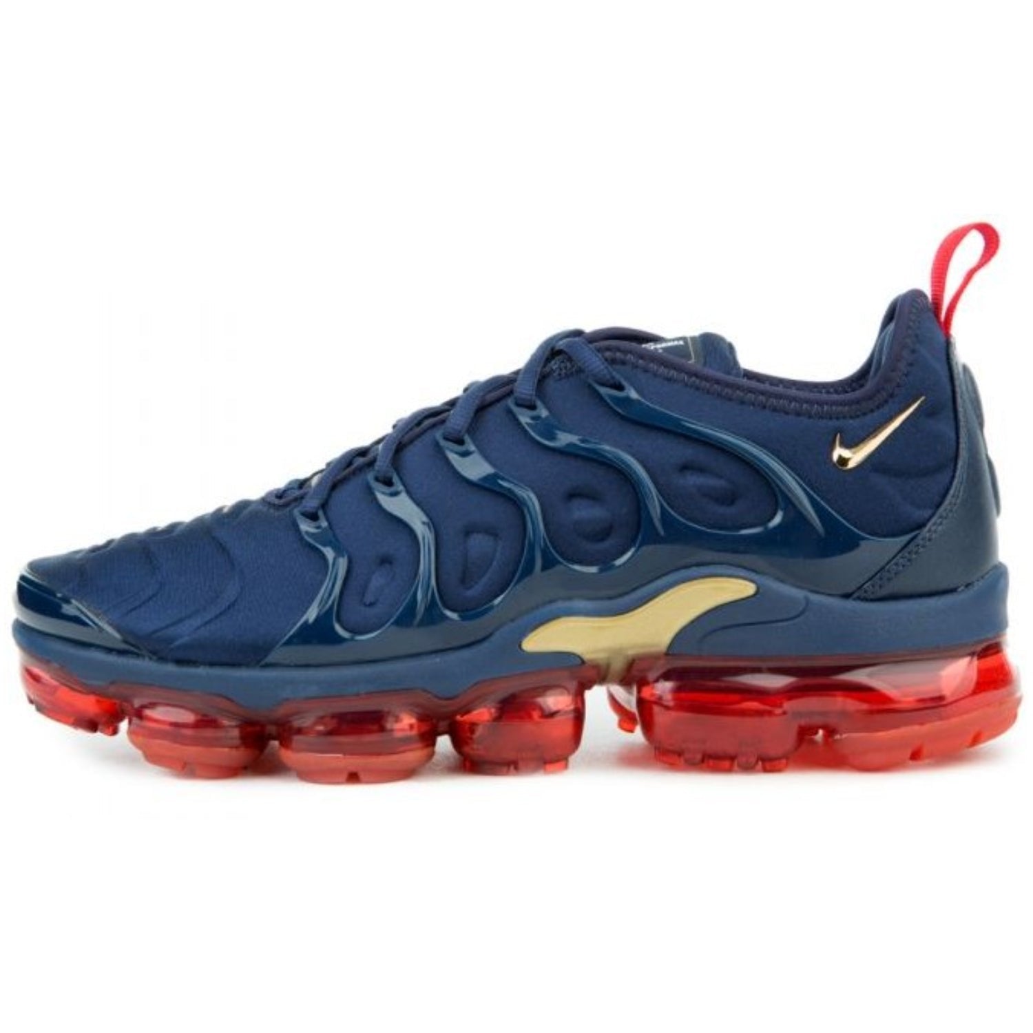 The Air Vapormax Plus "Midnight Navy/Metallic Gold-Black" features a gradient navy blue to metallic gold upper with black accents on the toe, eyelets, and heel. The wavy TPU design adds texture, and the clear Vapormax sole offers a sleek, cushioned finish, Available at Shoe Xport.