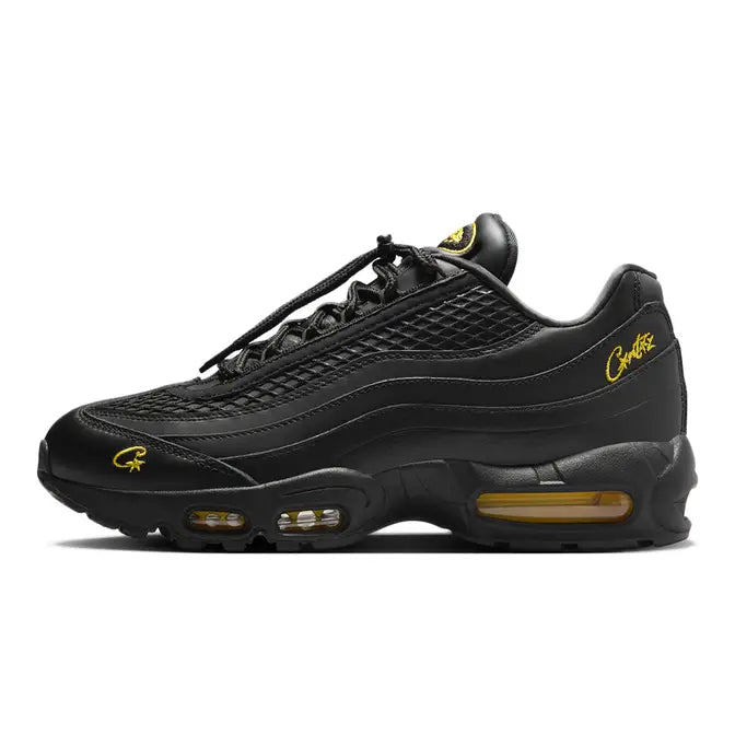 Side view of Corteiz x Nike Air Max 95 Black Tour Yellow sneakers, featuring a bold black upper with striking yellow accents, signature Air cushioning, and a sleek, collaborative design for standout style