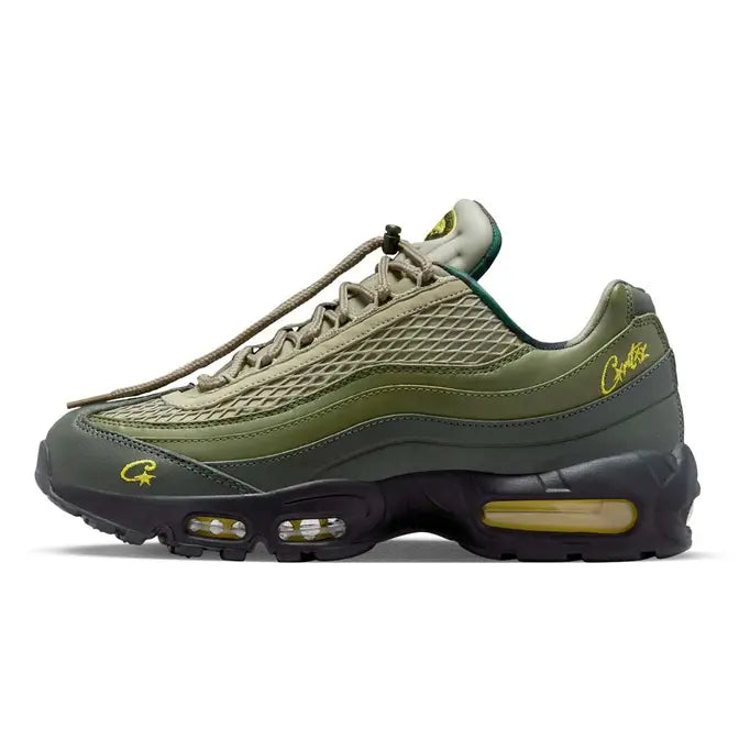 Close-up of the Corteiz x Nike Air Max 95 'Gutta Green' sneaker, featuring a gradient green and black upper, rugged mesh overlays, signature wavy paneling, and Corteiz branding details on the tongue and heel, available at Shoe Xport