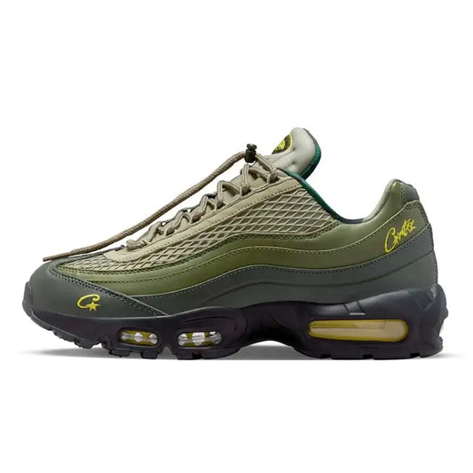 Close-up of the Corteiz x Nike Air Max 95 'Gutta Green' sneaker, featuring a gradient green and black upper, rugged mesh overlays, signature wavy paneling, and Corteiz branding details on the tongue and heel, available at Shoe Xport