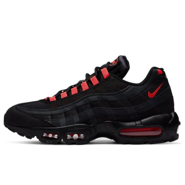 Side profile of the Nike Air Max 95 'Black Laser Crimson' (DA1513-001), featuring a sleek black upper with striking Laser Crimson accents on the lace loops, swoosh, and midsole. Designed with a mix of mesh and suede overlays, this sneaker delivers bold style and all-day comfort with its signature Air Max cushioning, available at Shoe Xport.